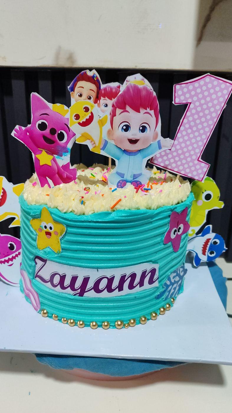 Baby Shark themed first birthday cake and dessert table