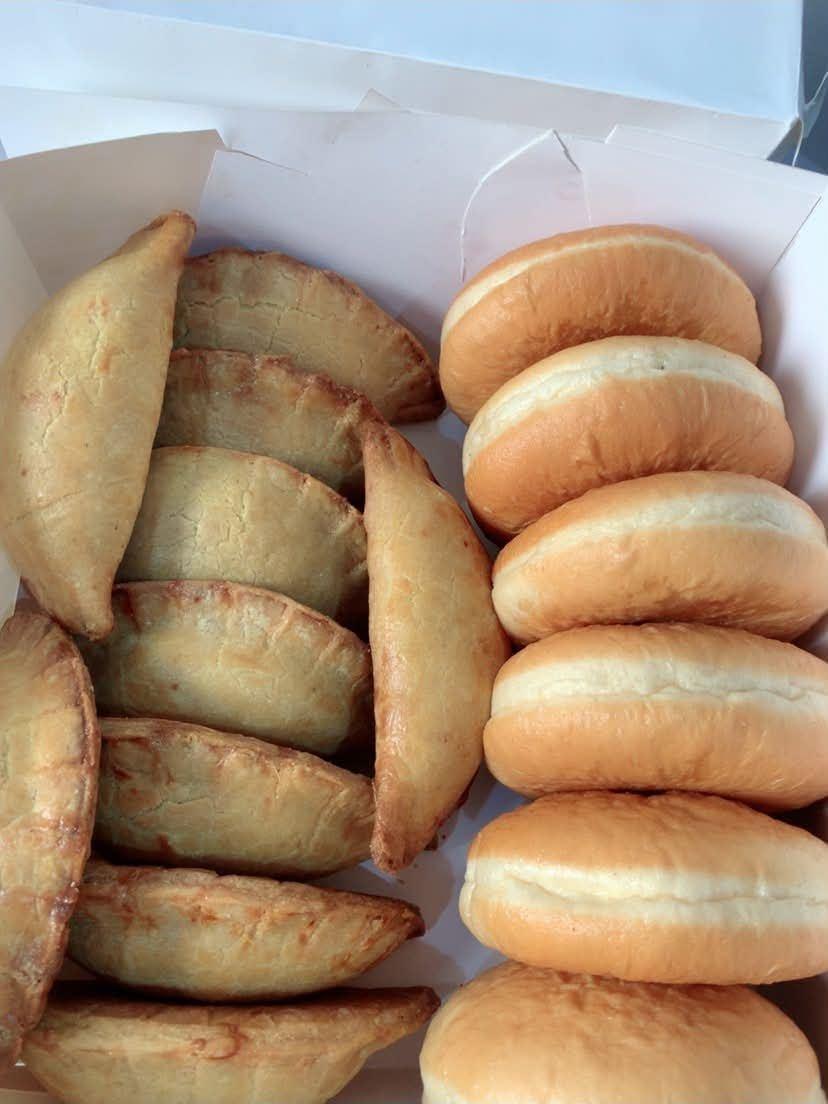 Freshly baked meat pies alongside soft burger buns